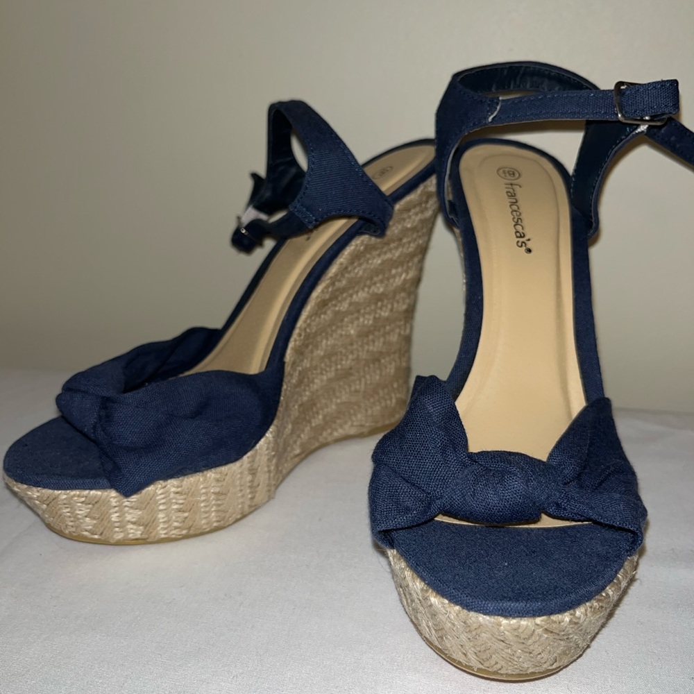 Navy blue espadrille wedges with ankle strap.